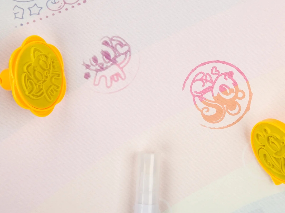 Relief stamps beside the colored prints they left on the mat